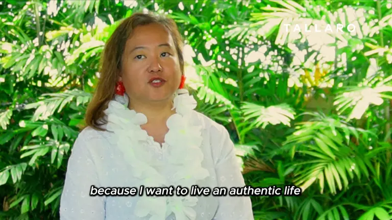 Dr. Anne Marie Morales speaking to camera among the greenery at the Tallaro Healing Center.